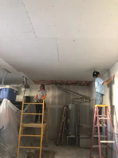 Drywall repair project photo showing wall or ceiling patch and finish work